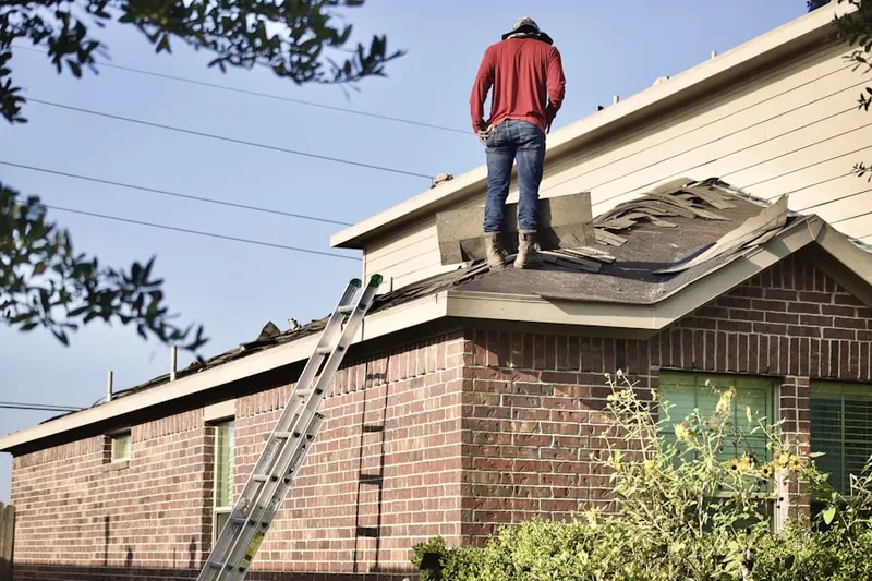 Professional roofer working on a residential roof in Buckman